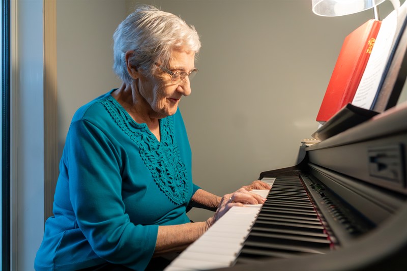 Elderly Woman Resident of Borden Care Home playing piano